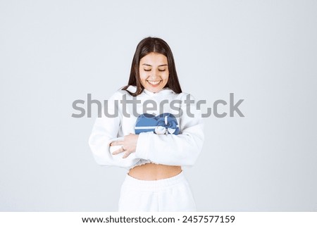 Picture of a pretty young girl model holding a heart shaped gift box. High quality photo