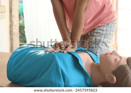 Close-up of CPR on doll's hand (Cardiopulmonary Resuscitation) A resuscitation technique used in emergencies to resuscitate a person who has stopped breathing or whose heart has stopped beating.