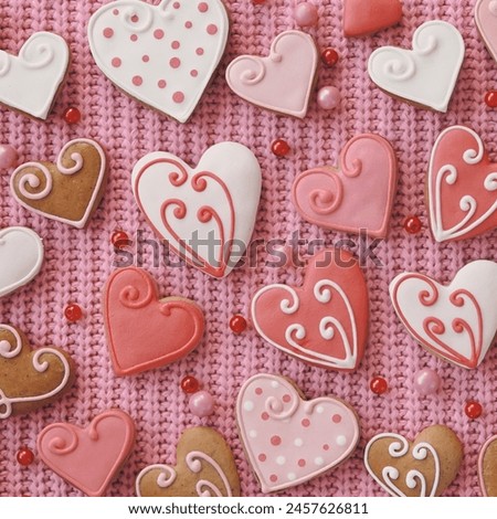 Background of gingerbread hearts on pink fabric. Valentine's Day Wallpapers. Wide Banner. Square Photo