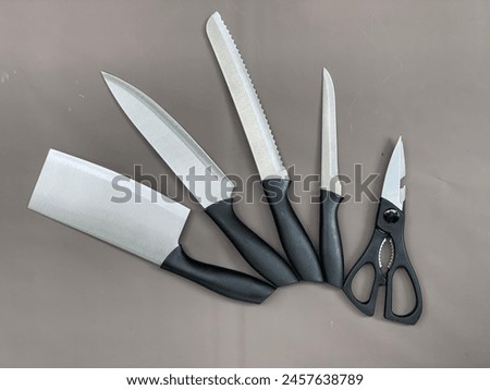 Sharp kitchen knife with shiny blade made of high quality steel. picture of a knife on a dark background. This knife appears well maintained and ready for any cooking task.