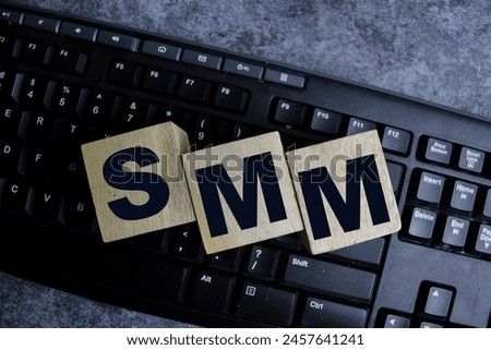 Concept of The wooden Cubes with the word SMM - Short for Social Media marketing on wooden background.