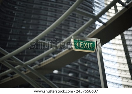 a close-up of a green exit sign with white lettering