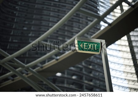 a close-up of a green exit sign with white lettering
