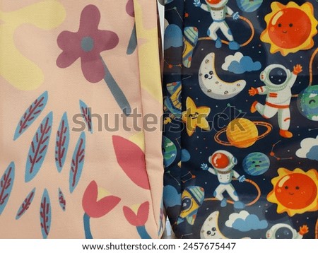 Illustration of space and flower motifs on the bag fabric next to each other.