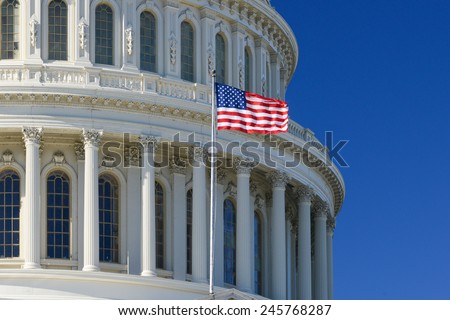 US Capitol Building dome detail with waving national flag - Washington DC, United States of America Royalty-Free Stock Photo #245768287