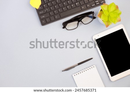 Tablet, calculator, phone, pen and a cup of coffee, lot of things on a light background. Top view with copy space