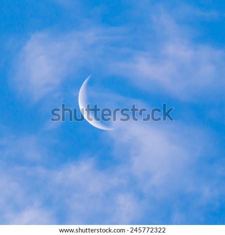moon on a blue sky with clouds