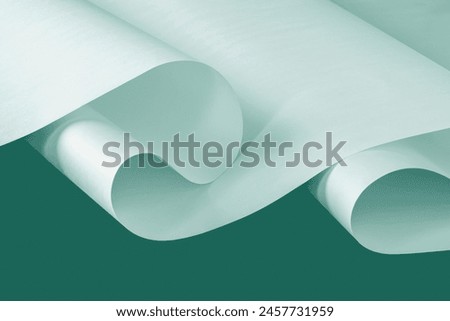A large unfolded sheet of white paper in a cool color scheme.