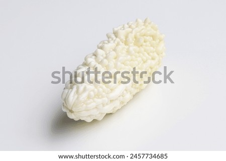 A fresh white bitter melon isolated on a white background. Bitter melon (Momordica charantia) is a tropical and subtropical vine of the family Cucurbitaceae grown for its edible fruit. Royalty-Free Stock Photo #2457734685