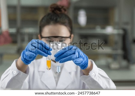 Female scientist looking at the scientific sample in the laboratory. Royalty-Free Stock Photo #2457738647