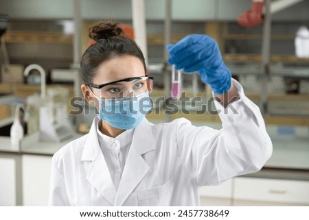 Female scientist looking at the scientific sample in the laboratory. Royalty-Free Stock Photo #2457738649