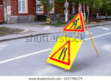 Road works sign at the city street. Carrying out construction and repair work in the city