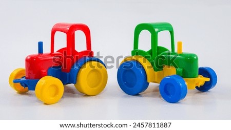 Plastic toy tractor on a white background.