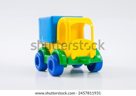 Plastic toy multi-colored truck on a white background.