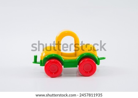Plastic toy car on a white background.