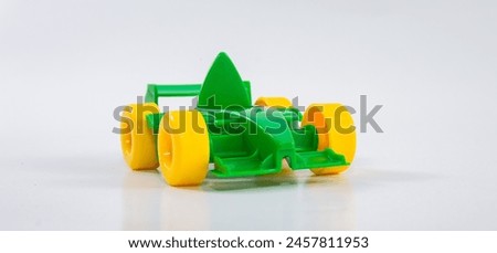 Plastic toy children's racing car on a white background.