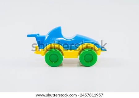 Plastic toy children's racing car on a white background.