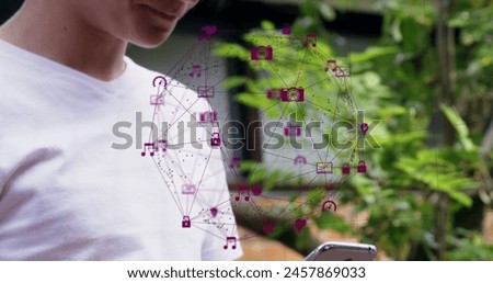 Image of globe of digital icons over caucasian boy using smartphone outdoors. Global networking and business technology concept