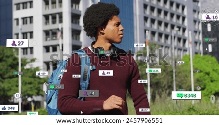 Image of changing numbers, icons over biracial man standing and looking at smartwatch. Digital composite, multiple exposure, business, growth, social media reminder and technology concept.