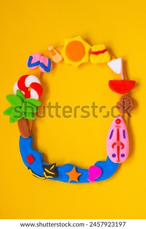 Made from playdough in frame made of summer theme on orange background