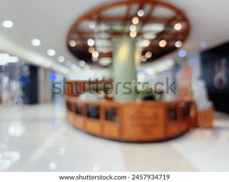 Blur focus of modern shopping mall corridor and storefront.
