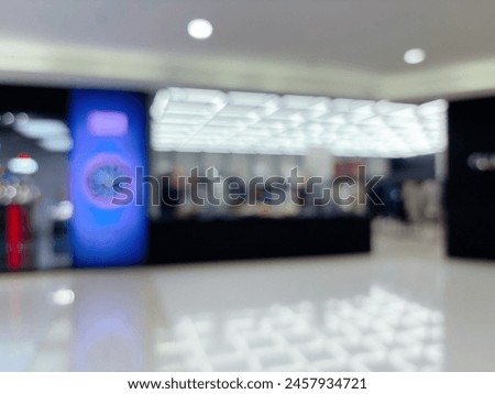 Blur focus of modern shopping mall corridor and storefront.