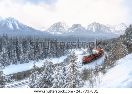 Beautiful scenic viewpoint of "Morant's Curve", near Lake Louise in Canada. Train is passing through the Canadian Rockies. It is a popular photographer location in Canada. Royalty-Free Stock Photo #2457937831