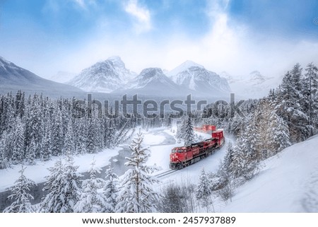 Beautiful scenic viewpoint of "Morant's Curve", near Lake Louise in Canada in blue sky. Train is passing through the Canadian Rockies. It is a popular photographer location in Canada. Royalty-Free Stock Photo #2457937889