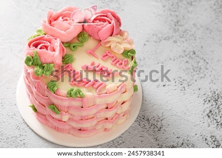 Mothers Day celebration cake with Love you Mom text, isolated on table. Space for text.