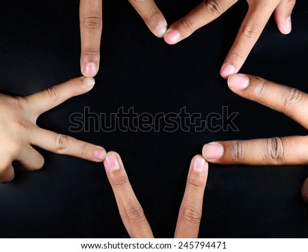 Many hands protecting isolated on a black background.