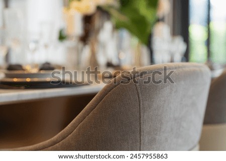 close up of nice dining chair with wooden table and dish sets interior design vintage color tone with light flare ,beautiful table setting for wedding or other celebration home design