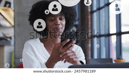 Image of profile icon in circles over biracial woman laughing and talking on cellphone. Digital composite, multiple exposure, business, abstract, communication and technology concept. Royalty-Free Stock Photo #2457981189