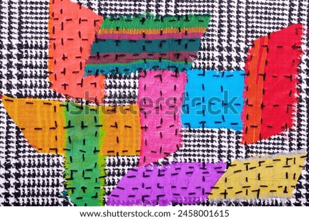 

Abstract multicolored textile background texture with stitches.