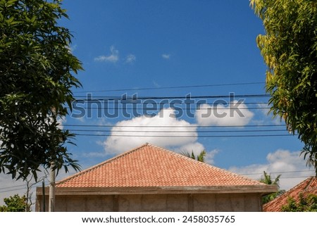 rooftops in the countryside with a clean blue sky