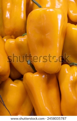 Close up shot of beautiful, healthy orange organic peppers in a wooden box. fresh fruit market, grower's market produce.