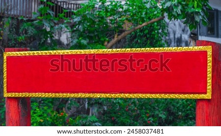Empty blank red gold welcome sign to wat buddhist temple in Luang Prabang Laos.