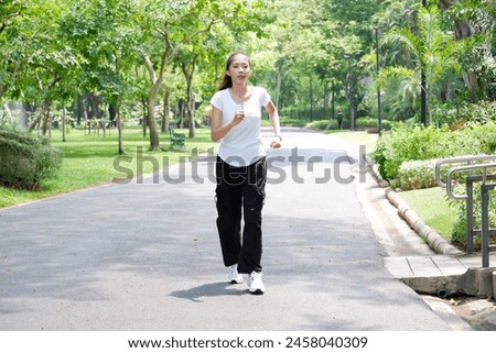 Young woman jogging in the park Exercise for health.