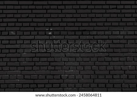 Old black brick wall. Abstract construction background.