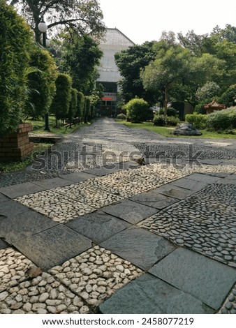a perspective photograph of a street corner of a park Royalty-Free Stock Photo #2458077219