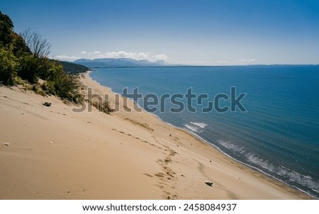 Rana e Hedhun coastal dune. Pristine beach where sand dunes climb nearly halfway up the face of the mountainside. Nature and travel. Albania, Lezhe  Royalty-Free Stock Photo #2458084937
