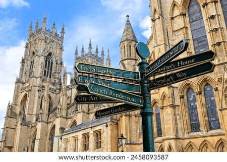 Sign post with landmarks in the city of York, England with defocused view of York Minster in the background.