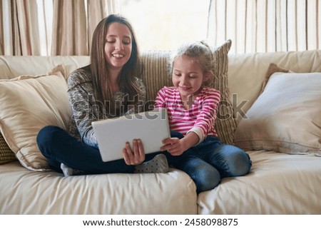 Children, girl and tablet on couch for online streaming, social media and happy in home. Family, sister and technology on sofa for internet, gaming and cartoon in living room with smile for holiday