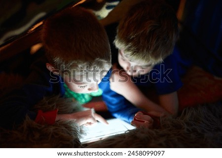 Home, children and brothers on tablet in tent for game, movie or streaming cartoon online at night together. Kids, siblings and technology to scroll on app, internet or family relax in fort in house