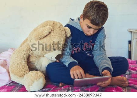 Child, tablet and relax in home bedroom on holiday with education games, app and growth. Online, reading and kid watch a movie with teddy bear on bed streaming cartoon, movies or film on website