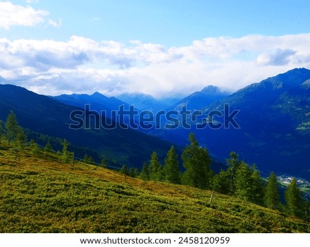 View on mountains in the Osttirol region on a summer day,mountains, sky, clouds. Lush green vegetation.  Alps, Austria.  Royalty-Free Stock Photo #2458120959