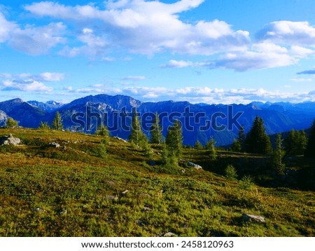View on mountains in the Osttirol region on a summer day,mountains, sky, clouds. Lush green vegetation.  Alps, Austria.  Royalty-Free Stock Photo #2458120963