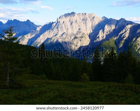 View on Lienzer Dolomiten mountains in the Osttirol region on a summer late afternoon,mountains, jagged rocks, sky, clouds.  Alps, Austria.  Royalty-Free Stock Photo #2458120977
