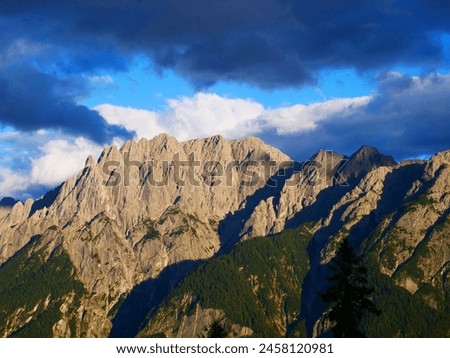 View on Lienzer Dolomiten mountains in the Osttirol region on a summer late afternoon,mountains, jagged rocks, sky, clouds.  Alps, Austria.  Royalty-Free Stock Photo #2458120981