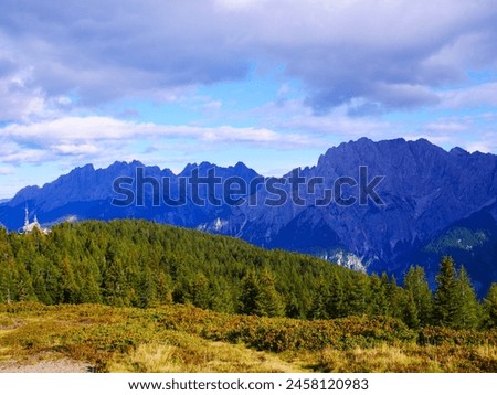 View on mountains in the Osttirol region on a summer day,mountains, sky, clouds. Lush green vegetation.  Alps, Austria.  Royalty-Free Stock Photo #2458120983