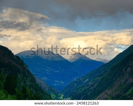 View on mountains in the Osttirol region on a summer day,mountains, sky, clouds. Lush green vegetation.  Alps, Austria.  Royalty-Free Stock Photo #2458121263